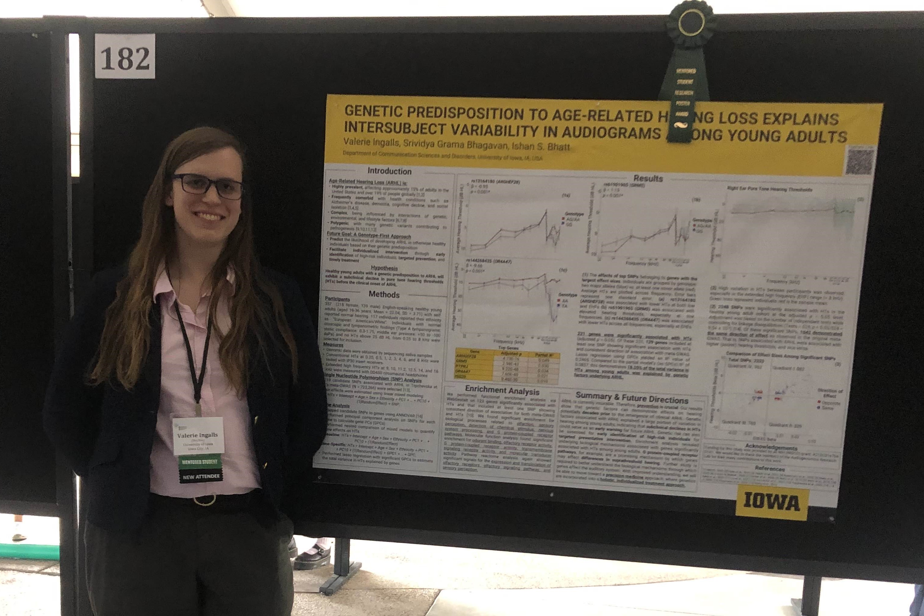 A photograph of the website's owner Valerie, standing next to her poster at a conference.